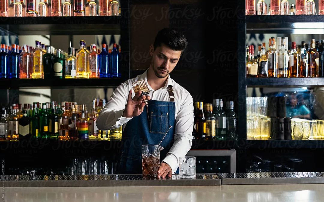 young bartender pouring a drink