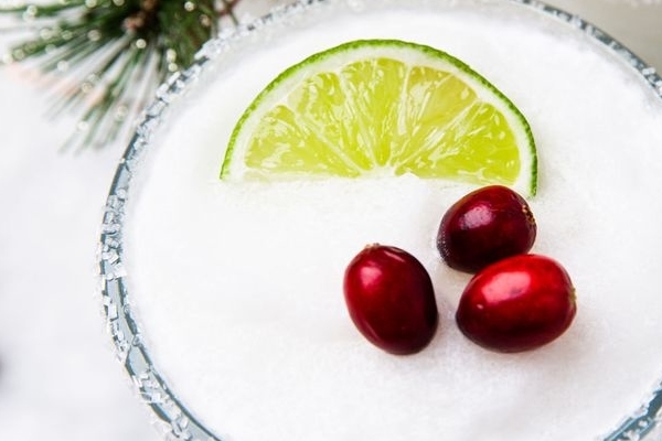 White Christmas Margarita served with cranberry garnish and rosemary sprig, the perfect holiday cocktail