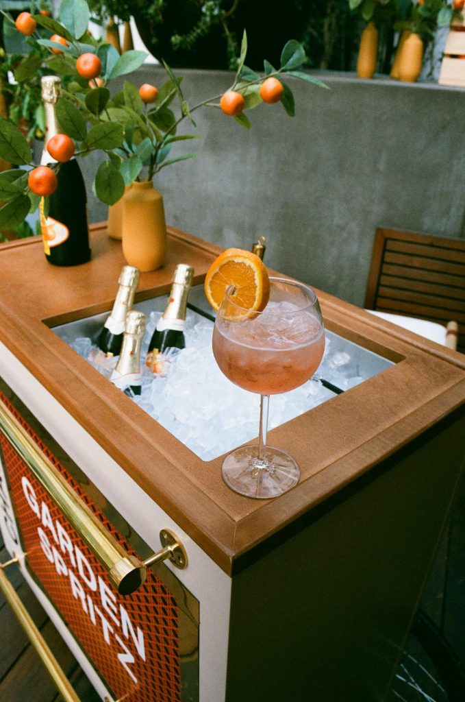 Outdoor bar cart setup with fresh citrus and spritz cocktails.