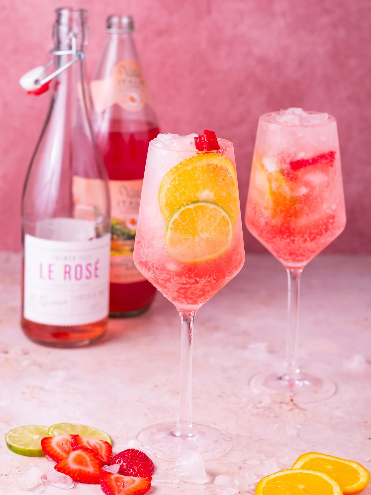 Rosé spritz cocktail with bubbles and strawberry garnish served in a wine glass at a sunny brunch
