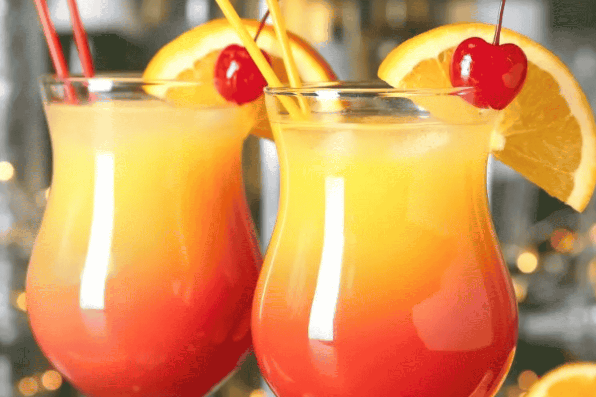 Bright and fruity Sex on the Beach cocktail with orange slice and cherry garnish