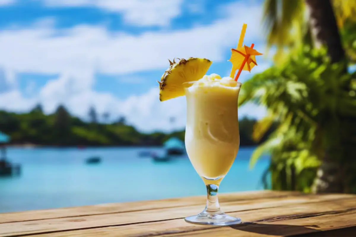 Creamy Piña Colada with pineapple garnish and cherry, served chilled on a summer day