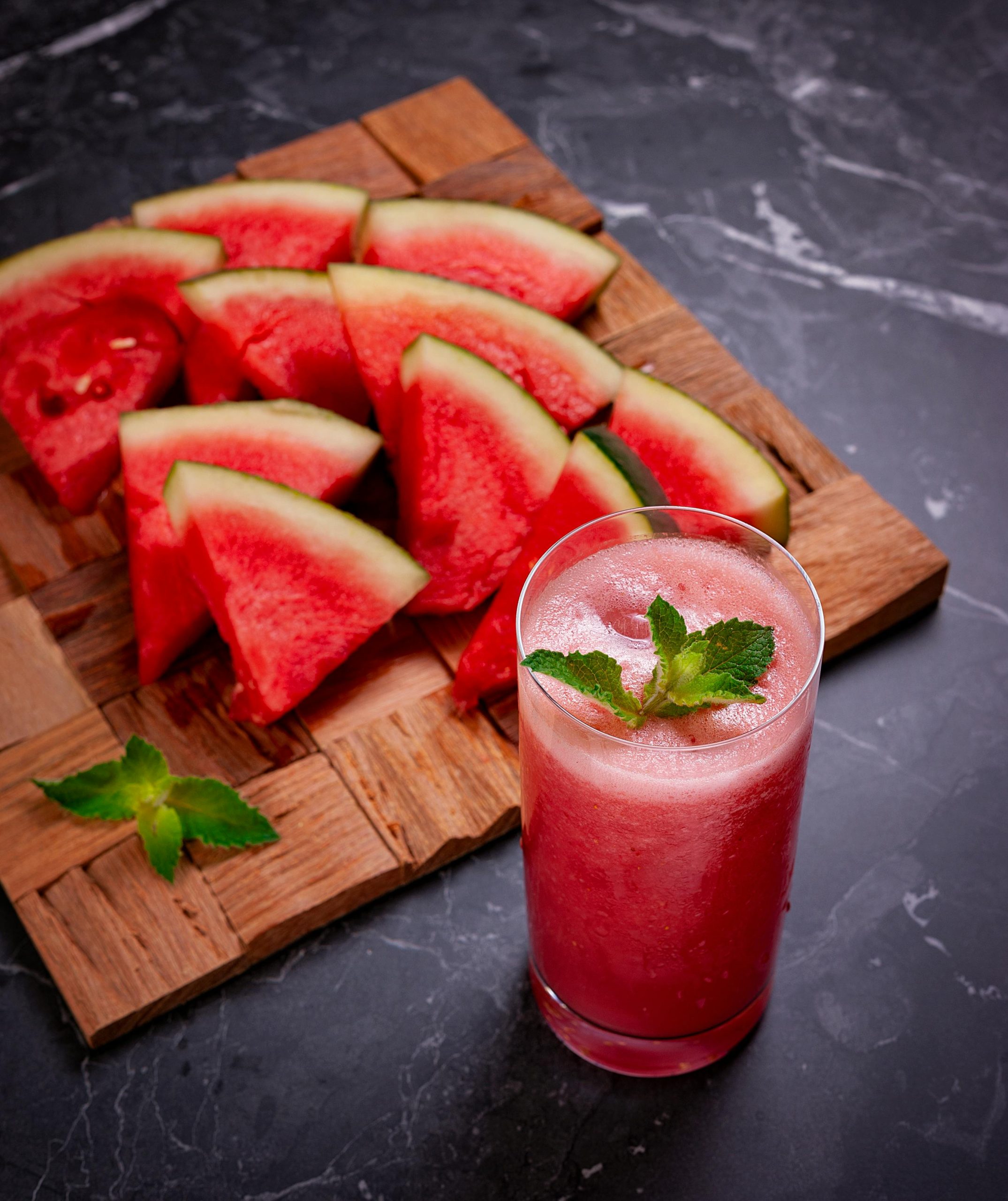 Refreshing Watermelon Breeze cocktail with basil garnish, perfect for pool parties and summer events