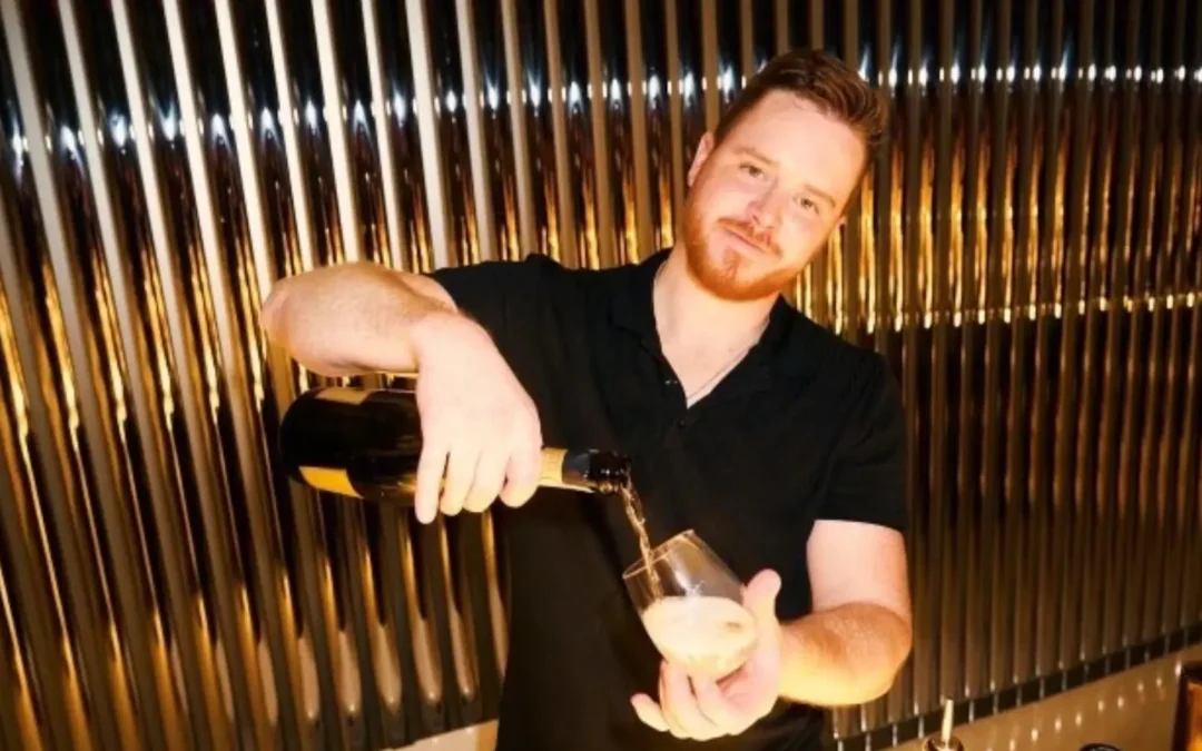 private bartender in formal attire pouring champagne into a glass to be served to guests