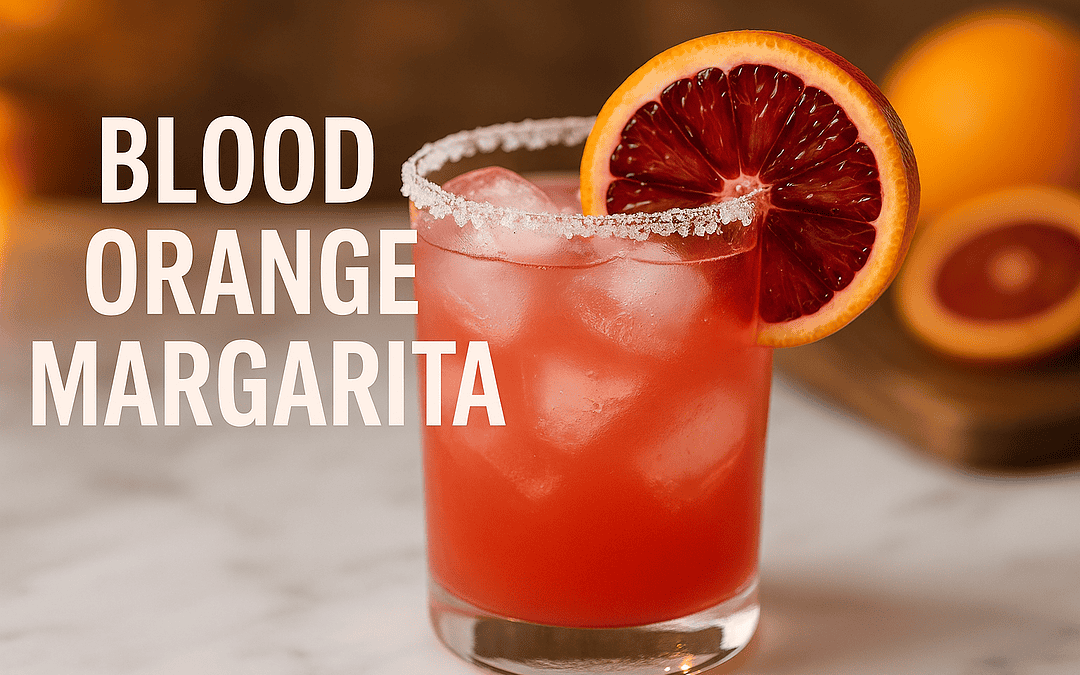 Blood Orange Margarita in a rocks glass with salted rim, ice cubes, and blood orange wheel garnish on marble bar top with blurred citrus background
