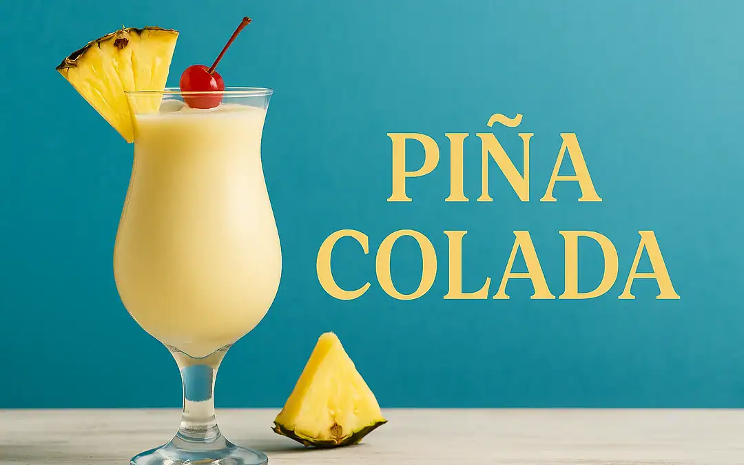 Piña Colada cocktail served in a hurricane glass with pineapple wedge and cherry garnish on a summer bar top with tropical background