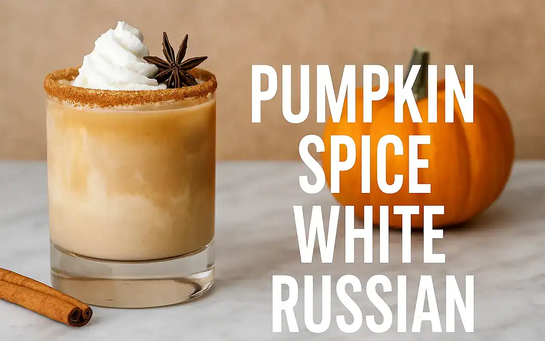 Pumpkin Spice White Russian cocktail with whipped cream, cinnamon rim, and star anise garnish served in a short glass on a marble bar top with autumn decor