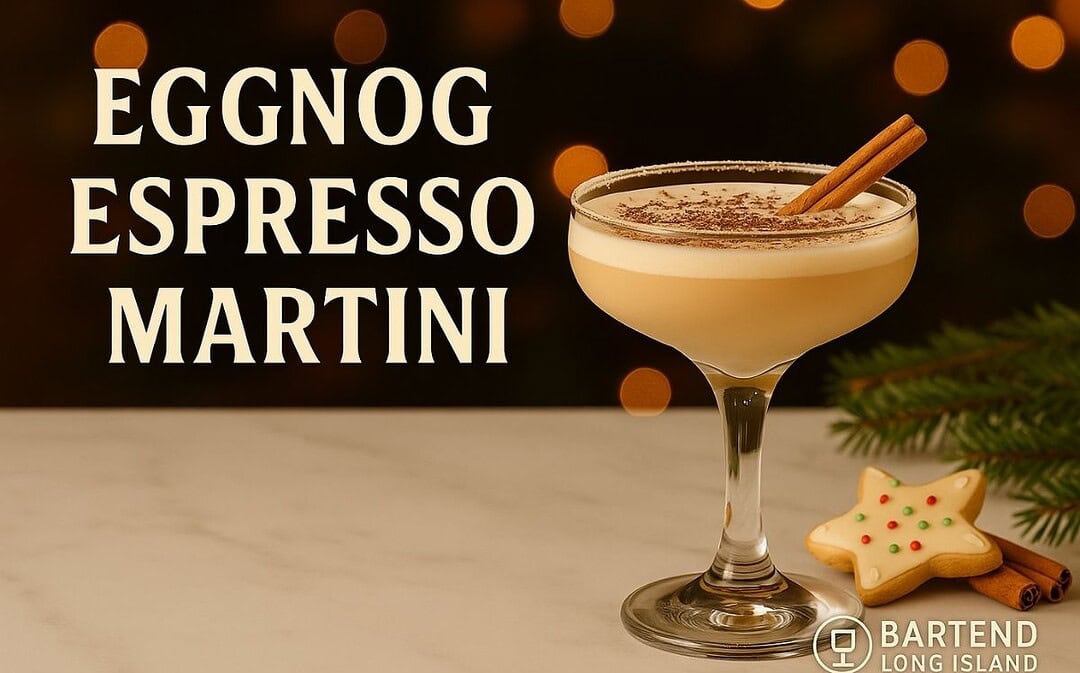 Eggnog Espresso Martini in a coupe glass with a creamy layered top, dusted with chocolate and garnished with a cinnamon stick, set on marble with a decorated Christmas cookie, pine sprigs, warm golden bokeh lights, and the Bartend Long Island watermark.