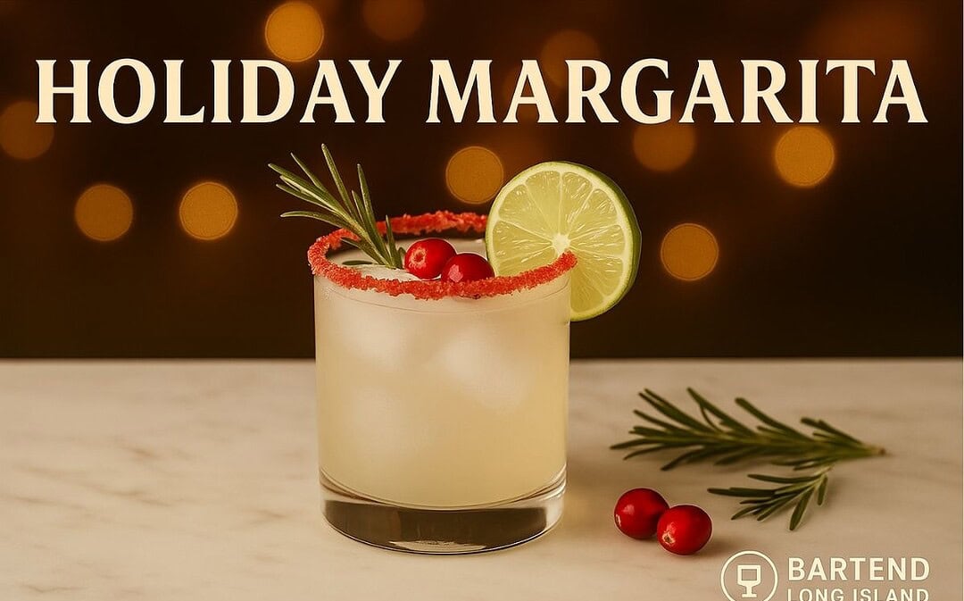 Holiday Margarita in a short glass with a red sugared rim, garnished with cranberries, lime slice, and rosemary sprig, set on a marble surface with golden holiday lights and Bartend Long Island logo watermark.