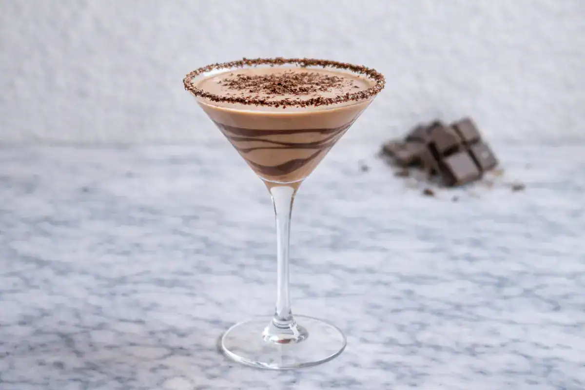 Chocolate martini in a chilled coupe glass with chocolate shavings on top on a bright, clean background