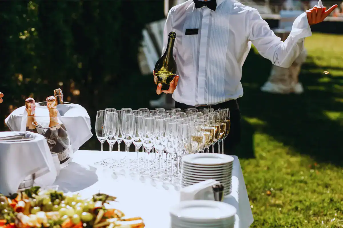 Wedding bartender pouring champagne at a professional bar setup on Long Island