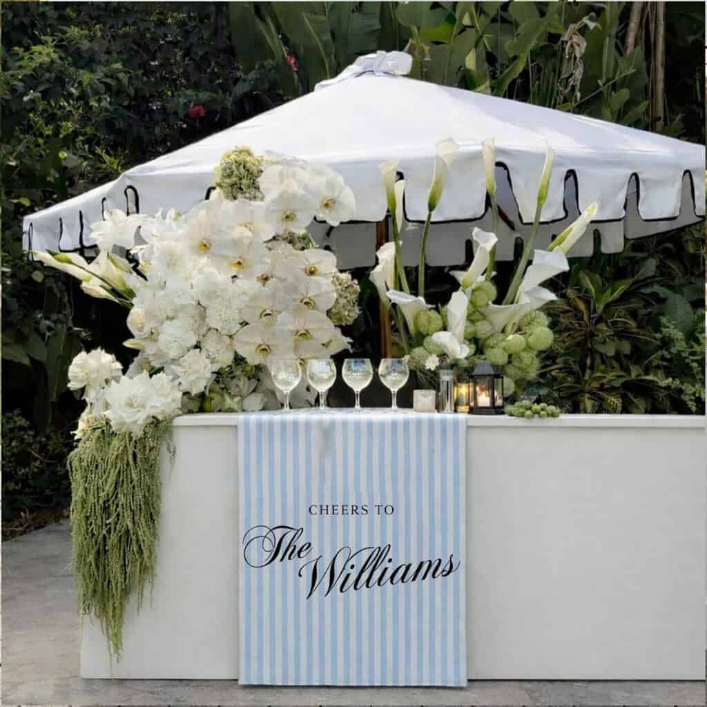 Personalized fabric wedding bar banner displayed on the front of a white bar