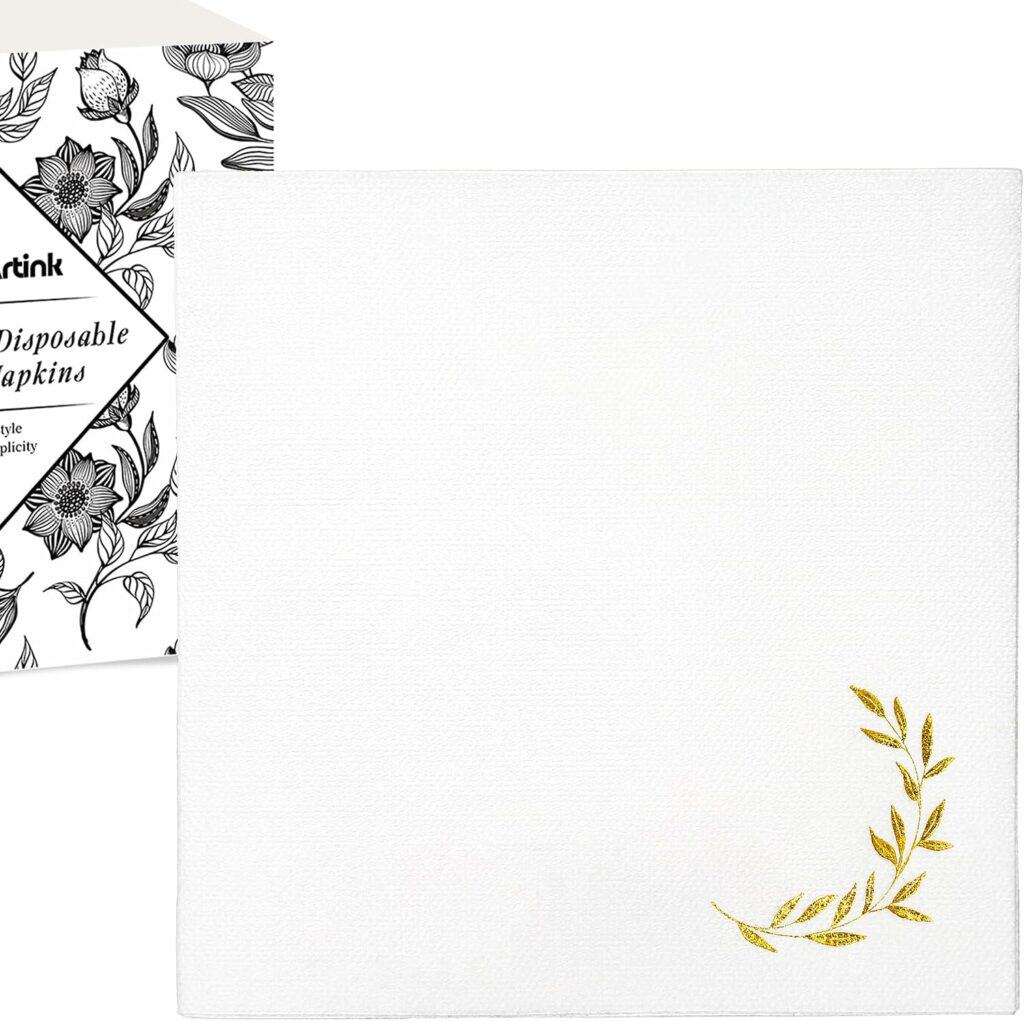White linen feel cocktail napkin with a gold foil botanical accent