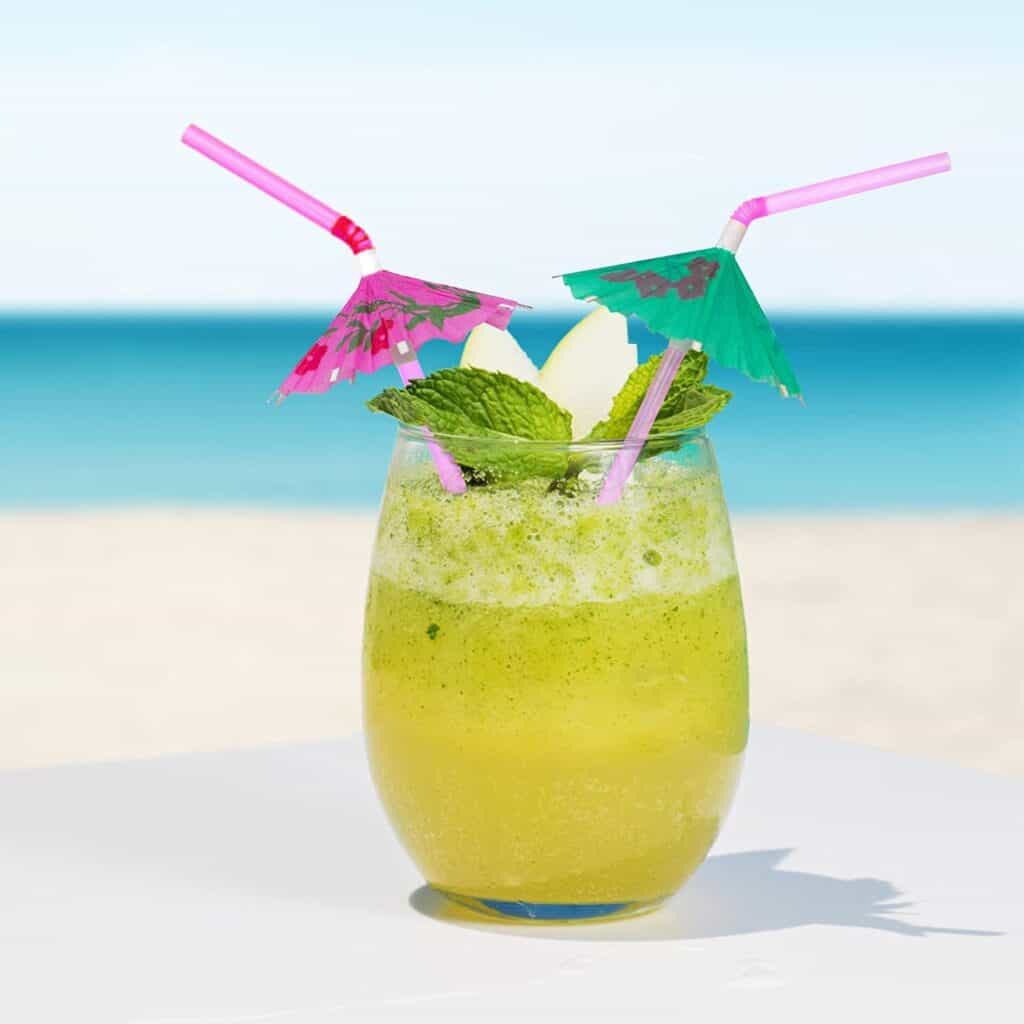 Colorful tropical umbrella drinking straws in a mint cocktail