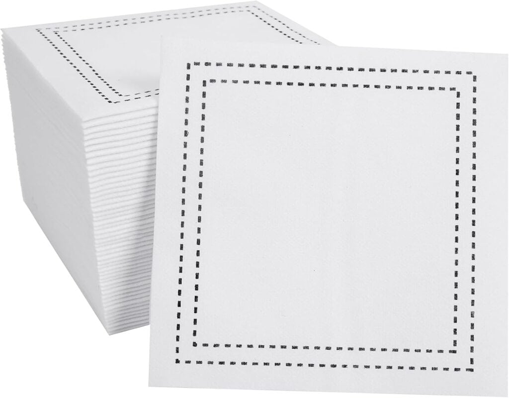 White linen feel disposable cocktail napkins with black stitched border